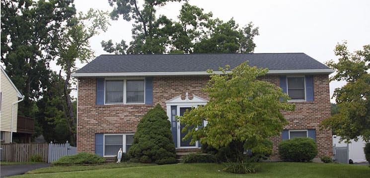 front view of brick house showing new roofing