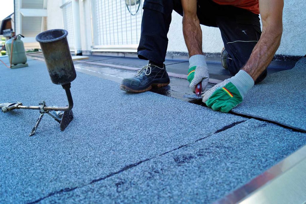 man picking out the right roofing materials to replace a roof