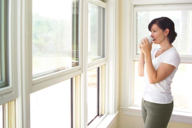 Woman admiring her new energy efficient windows in Baltimore