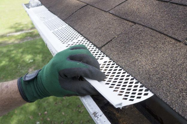a person finding out What Are Gutter Guards?