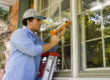 man installing Insulated Windows to cut energy costs