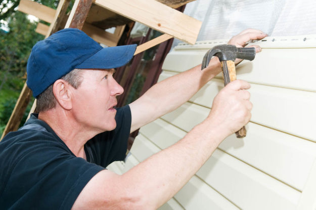a man installs the best siding for a house