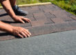 man laying shingles for new residential roof