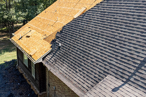 Residential home with new roof half-way installed.