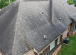 residential roof with storm damage
