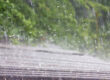 Heavy rain falling on a residential roof