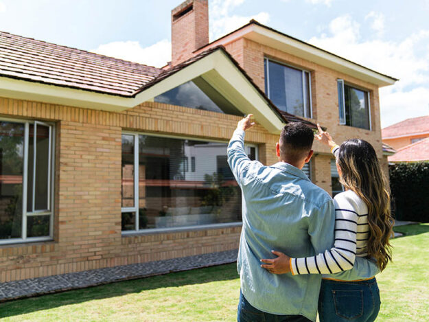 Homeowners looking up at roof.