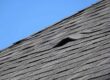 Lifted roof shingles from an improper roof installation.