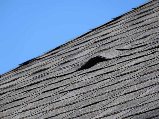 roof-installation-mistakes Lifted roof shingles from an improper roof installation.