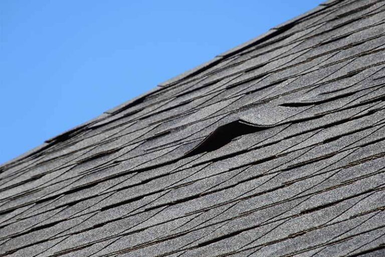 Lifted roof shingles from an improper roof installation.