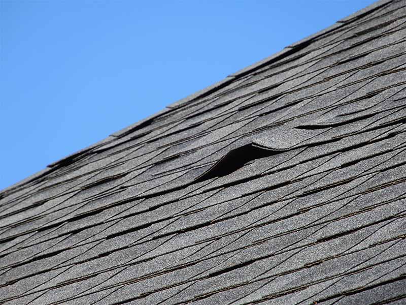 roof-installation-mistakes Lifted roof shingles from an improper roof installation.